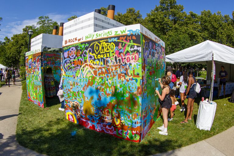 Visitors paint a set in the Arts Festival's Hands-On Activities Village